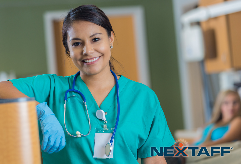 Attractive nurse standing at work, smiling.